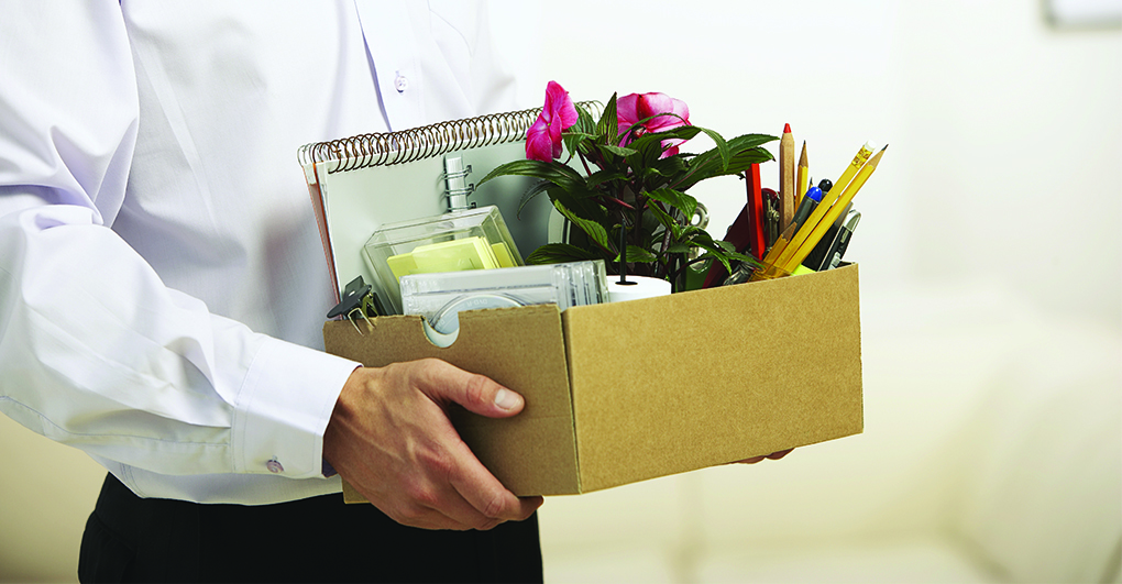 Man carrying a box with is work belongings