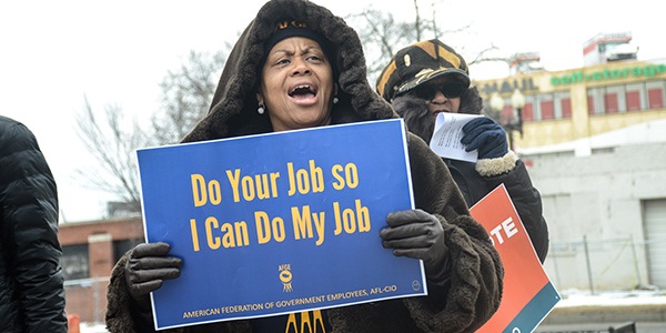 Rally goer holding sign that says Do you job so I can do my job