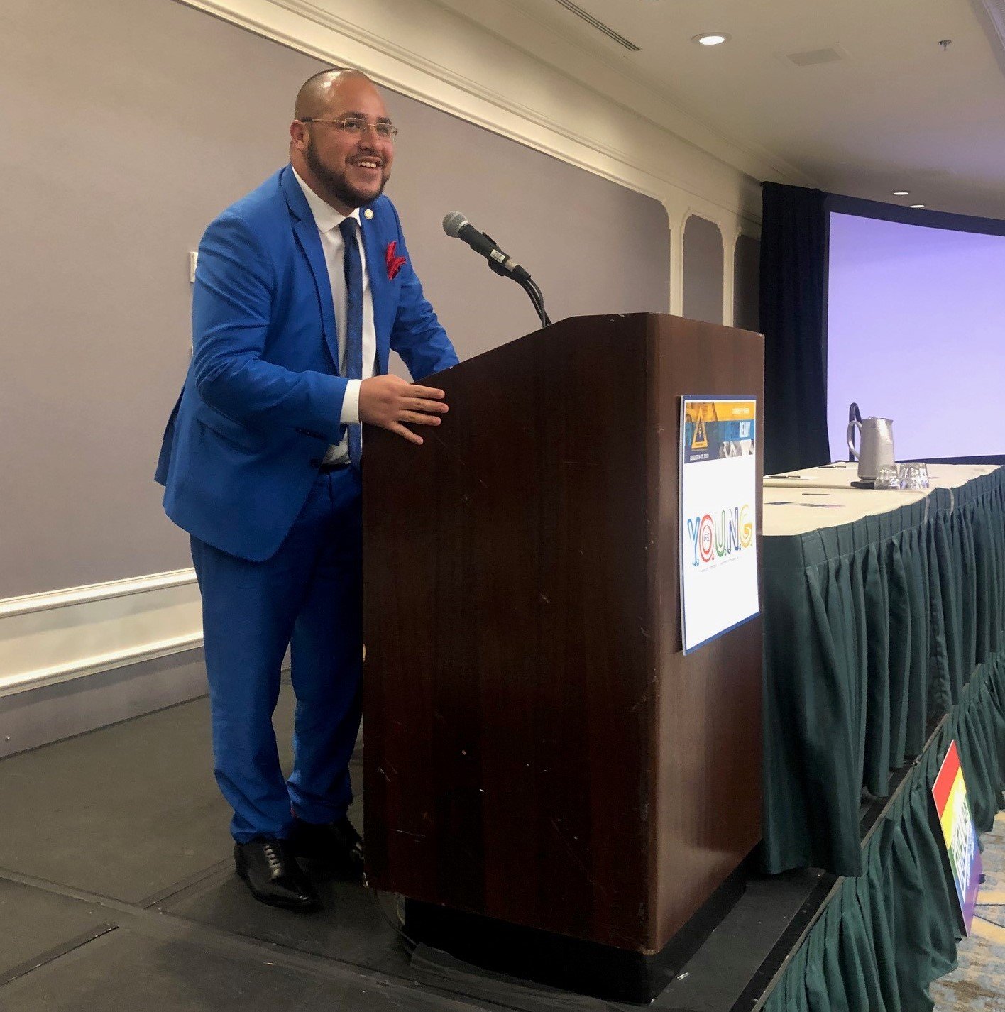 Freddie Cuellar speaking at a podium