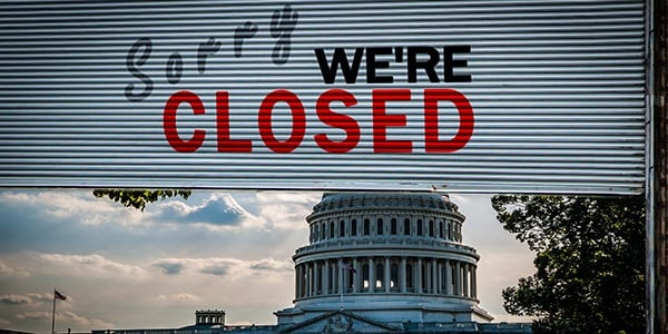 Capitol Hill with a sorry we're closed sign
