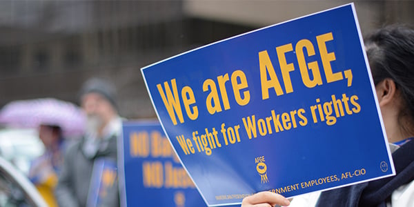 AFGE activist holding a rally sign