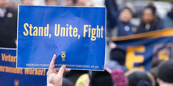 AFGE rally sign that reads Stand, Unite, Fight