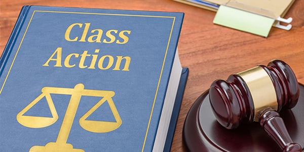 Stock photo of gavel and book that says class action lawsuit