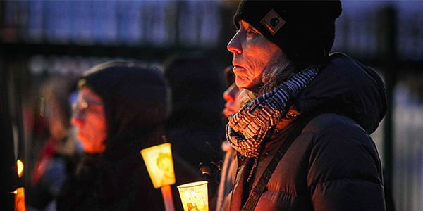 Person holding a candle at a candlelight vigil