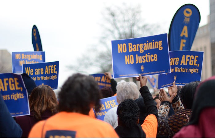 People at a rally holding signs